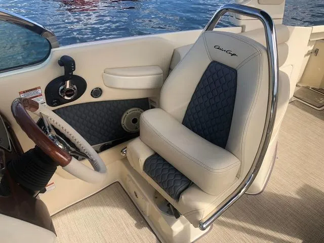 Slide: The Image of 2022 Chris-Craft Launch 28 GT boat interior with luxury seating and steering wheel. - 12