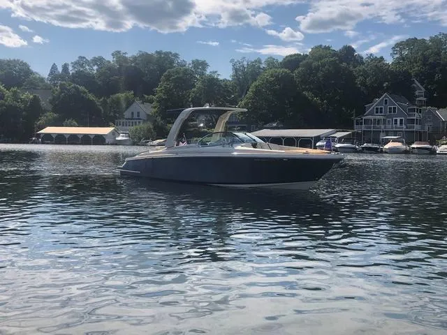 Slide: The Image of 2022 Chris-Craft Launch 28 GT boat on a serene lake with scenic background. - 3