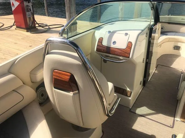 Slide: The Image of 2022 Chris-Craft Launch 28 GT interior with elegant wood accents and plush seating. - 9