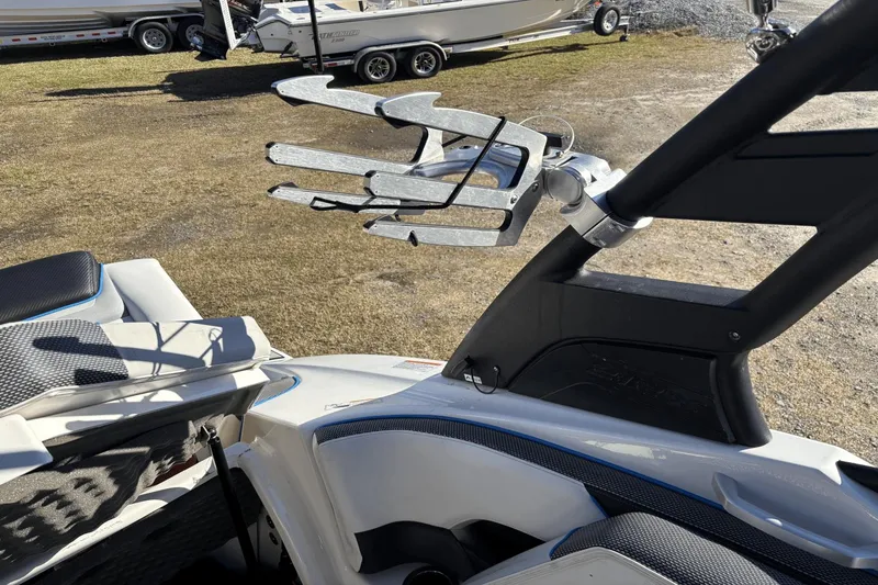 Slide: The Image of 2021 Yamaha Boats 212XE interior with wakeboard rack, showcasing sleek design and functionality. - 17