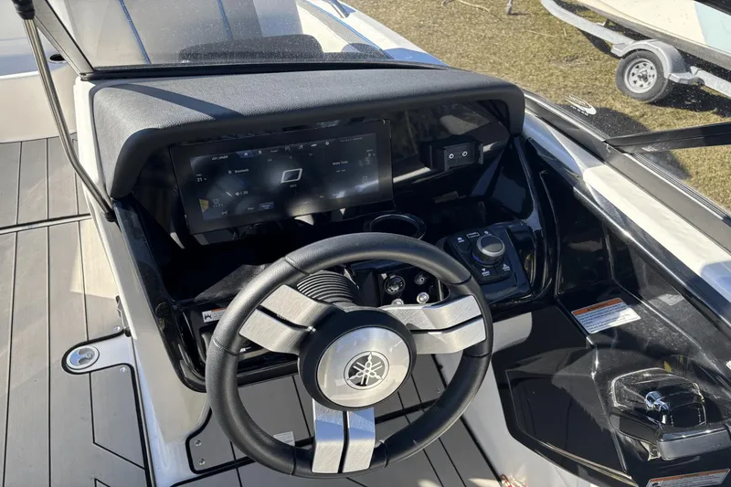 Slide: The Image of 2021 Yamaha Boats 212XE dashboard with steering wheel and digital display. - 18