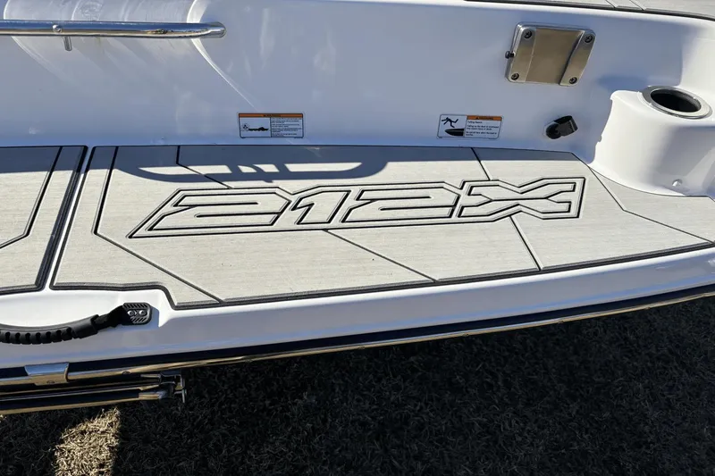 Slide: The Image of 2021 Yamaha Boats 212XE swim platform with logo and safety warnings. - 4