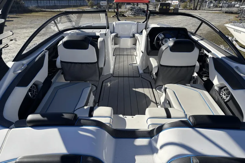 Slide: The Image of 2021 Yamaha Boats 212XE interior with sleek seating and modern dashboard design. - 9