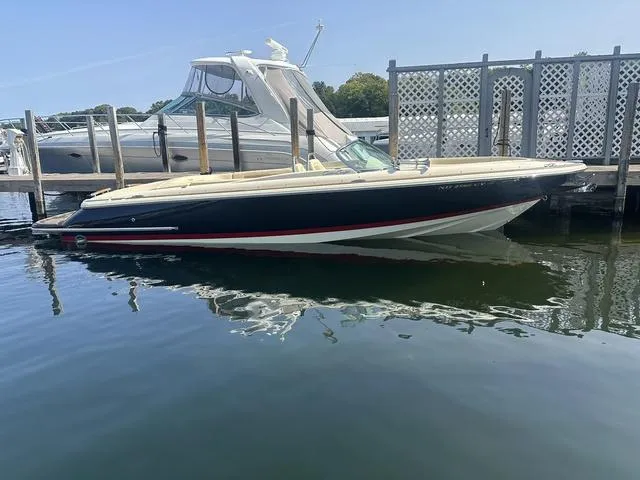 Slide: The Image of 2021 Chris-Craft Launch 27 boat docked in marina, calm water reflection. - 1