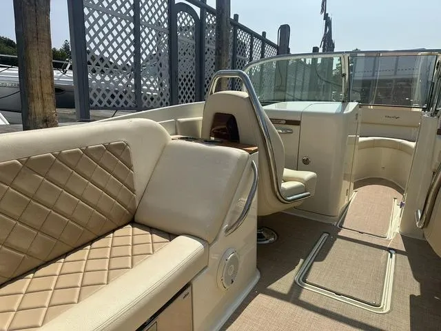 Slide: The Image of 2021 Chris-Craft Launch 27 boat interior with beige quilted seating and sleek design. - 10