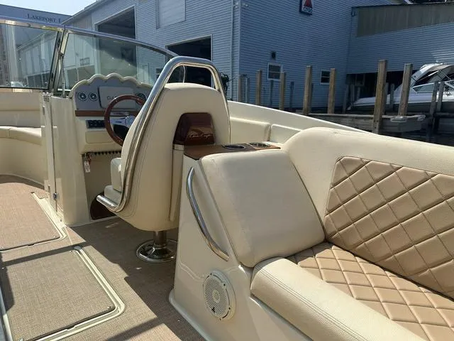 Slide: The Image of 2021 Chris-Craft Launch 27 interior with beige leather seating and wooden steering wheel. - 11