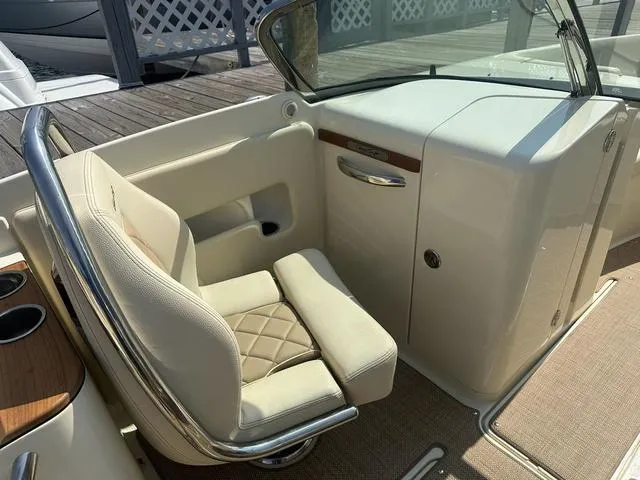 Slide: The Image of 2021 Chris-Craft Launch 27 boat interior with beige seating and elegant dashboard. - 12