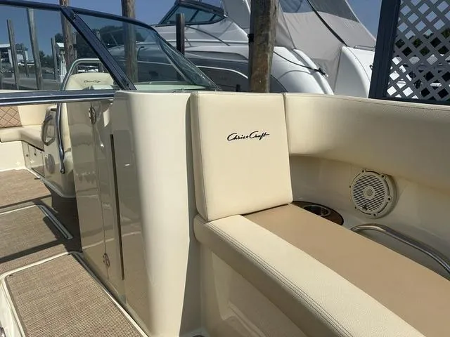 Slide: The Image of 2021 Chris-Craft Launch 27 boat interior with beige seating and speaker. - 17