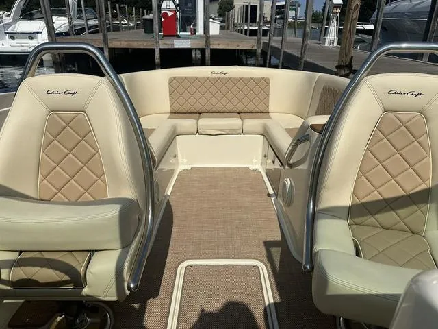Slide: The Image of 2021 Chris-Craft Launch 27 boat interior with beige diamond-stitched seating. - 18