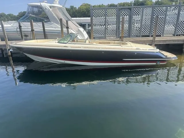 Slide: The Image of 2021 Chris-Craft Launch 27 boat docked in marina, side view. - 2