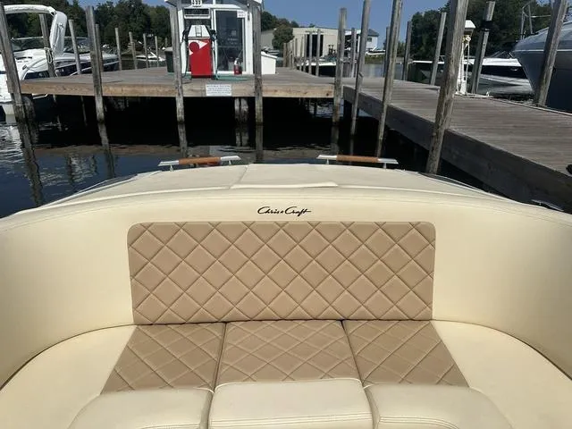 Slide: The Image of 2021 Chris-Craft Launch 27 boat with beige quilted seating at a marina dock. - 22