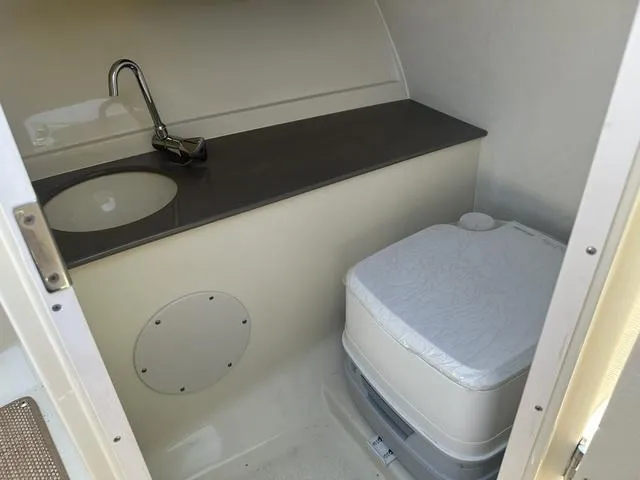 Slide: The Image of 2021 Chris-Craft Launch 27 boat interior with sink and portable toilet. - 23