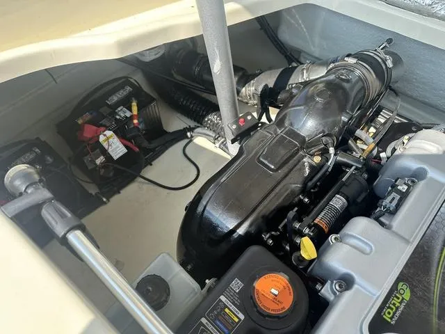 Slide: The Image of 2021 Chris-Craft Launch 27 engine compartment, showcasing detailed components and battery setup. - 25