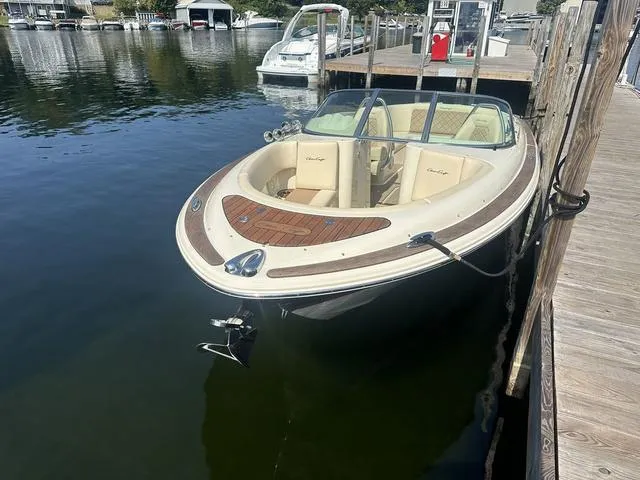 Slide: The Image of 2021 Chris-Craft Launch 27 boat docked on calm water. - 6