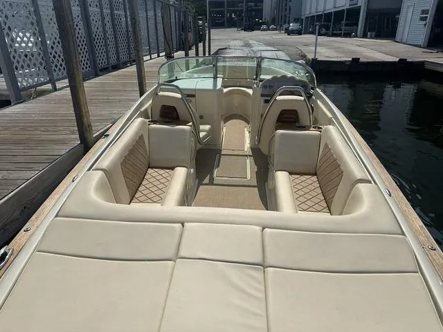 Slide: The Image of 2021 Chris-Craft Launch 27 boat with beige leather seating docked at marina. - 9