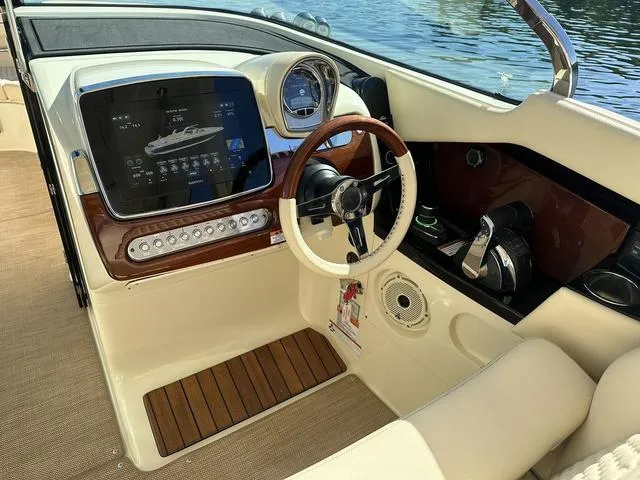 Slide: The Image of 2021 Chris-Craft Launch 31 GT cockpit with modern controls and wooden accents. - 11