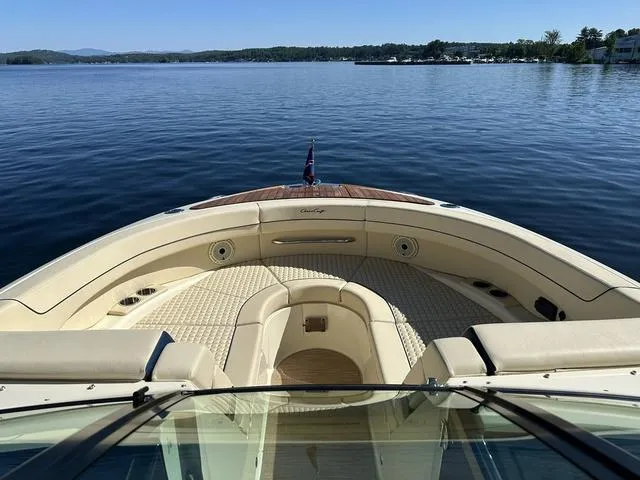 Slide: The Image of 2021 Chris-Craft Launch 31 GT on serene lake with clear skies. - 13