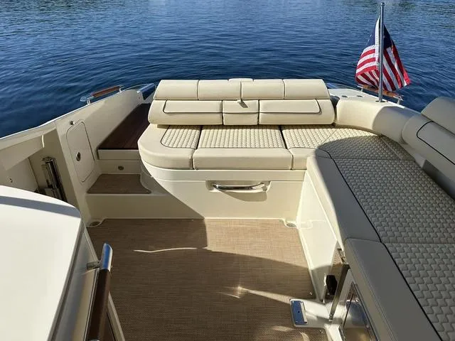 Slide: The Image of 2021 Chris-Craft Launch 31 GT boat interior with seating and American flag. - 22
