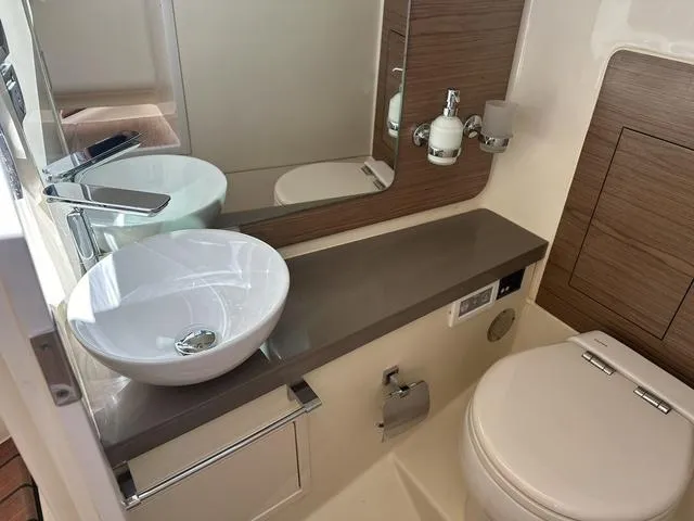 Slide: The Image of 2021 Chris-Craft Launch 31 GT bathroom with modern sink and toilet. - 26