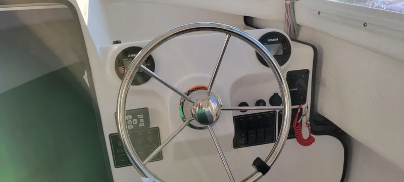 Slide: The Image of Steering wheel of 2025 C-Dory 22' Cruiser boat with control panel. - 4