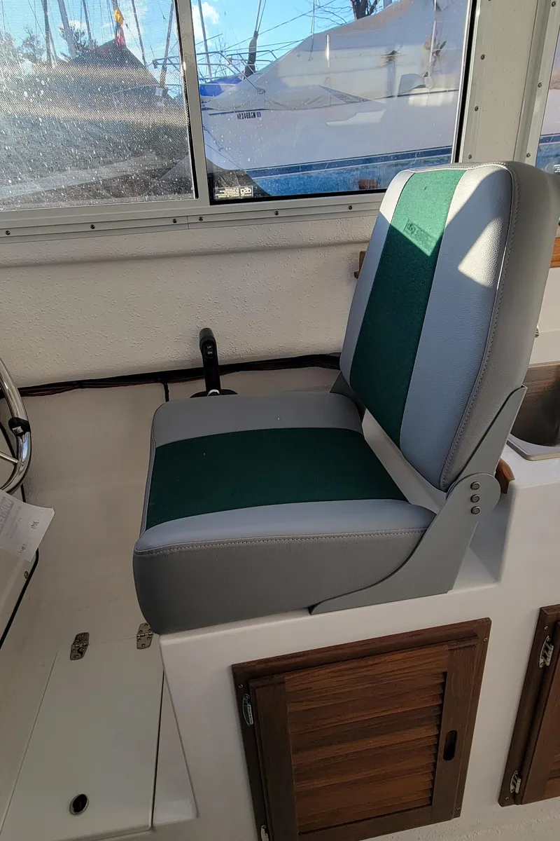 Slide: The Image of 2025 C-Dory 22' Cruiser interior with green and gray seating. - 5