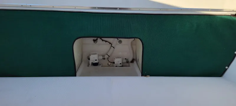 Slide: The Image of 2025 C-Dory 22' Cruiser boat interior with green panel and wiring compartment. - 9