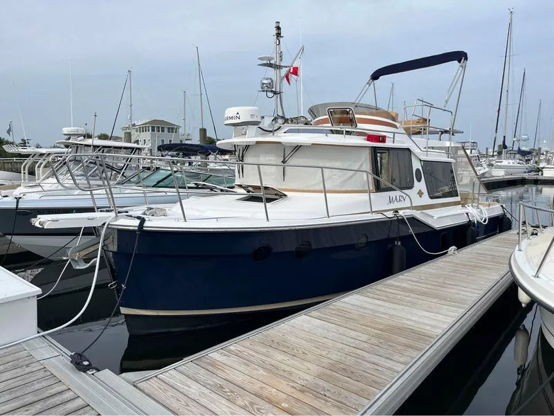 The Image of 2020 Ranger Tugs R-29 CB docked at marina, featuring sleek design and spacious deck. - 0