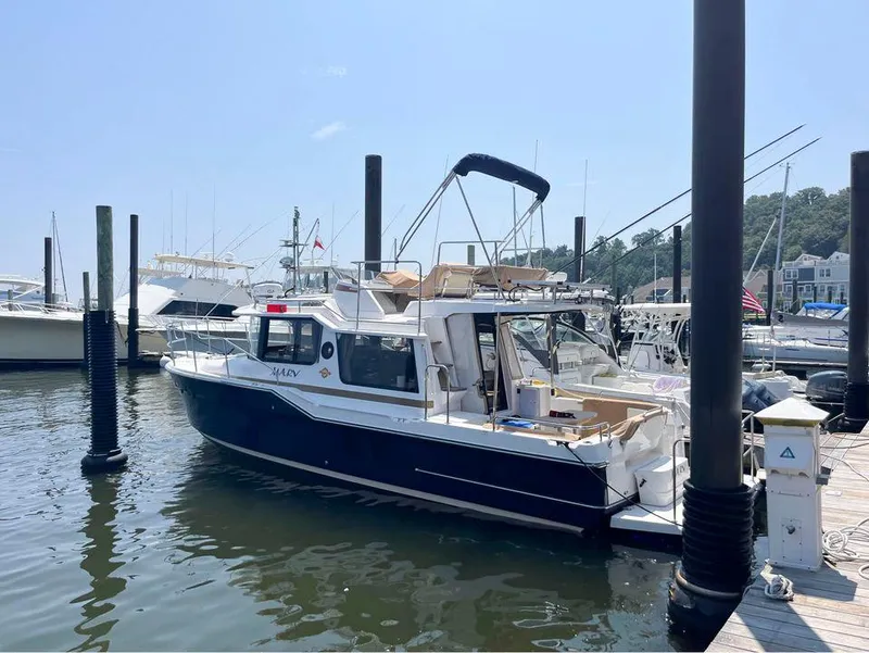 Slide: The Image of 2020 Ranger Tugs R-29 CB docked at marina under clear sky. - 3