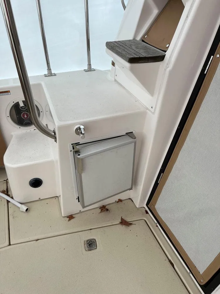 Slide: The Image of 2020 Ranger Tugs R-29 CB boat interior with storage compartment and steps. - 6