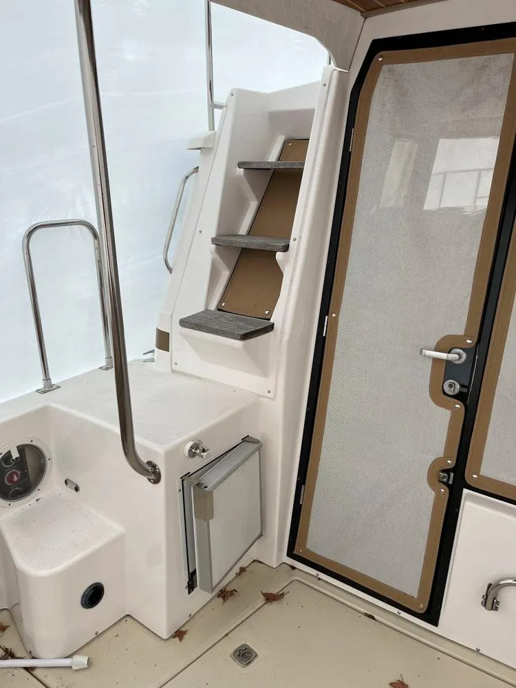 Slide: The Image of 2020 Ranger Tugs R-29 CB interior with stairs and door, showcasing modern design. - 8