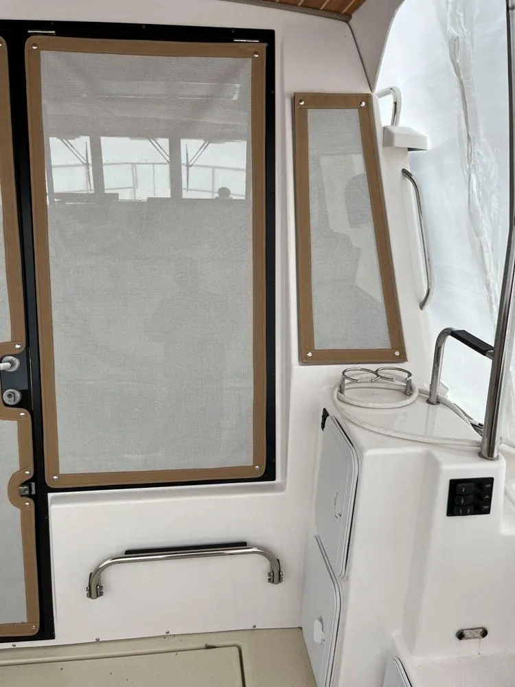 Slide: The Image of 2020 Ranger Tugs R-29 CB interior with door and window details. - 9