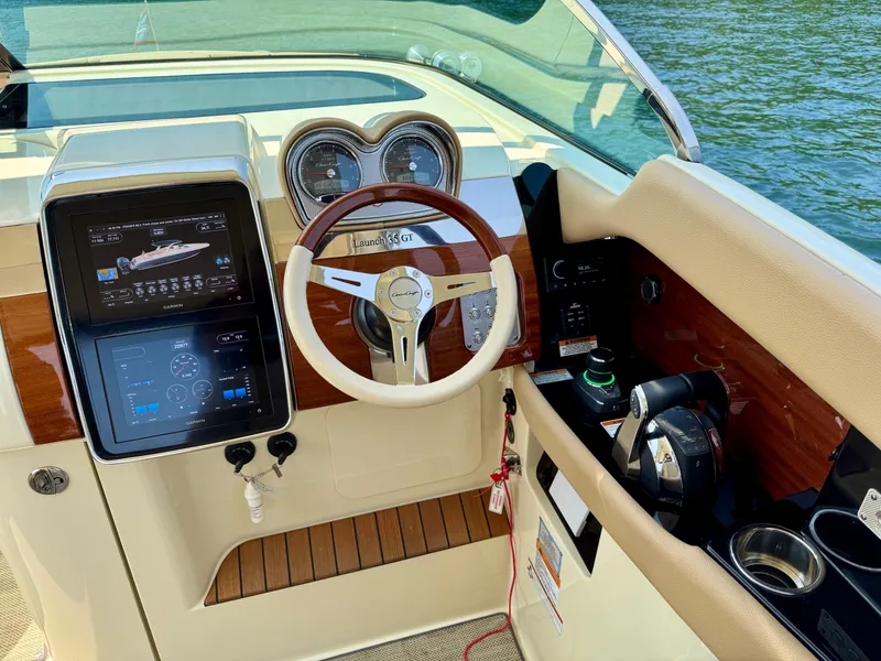 Slide: The Image of 2021 Chris-Craft Launch 35 GT dashboard with steering wheel and navigation displays. - 12