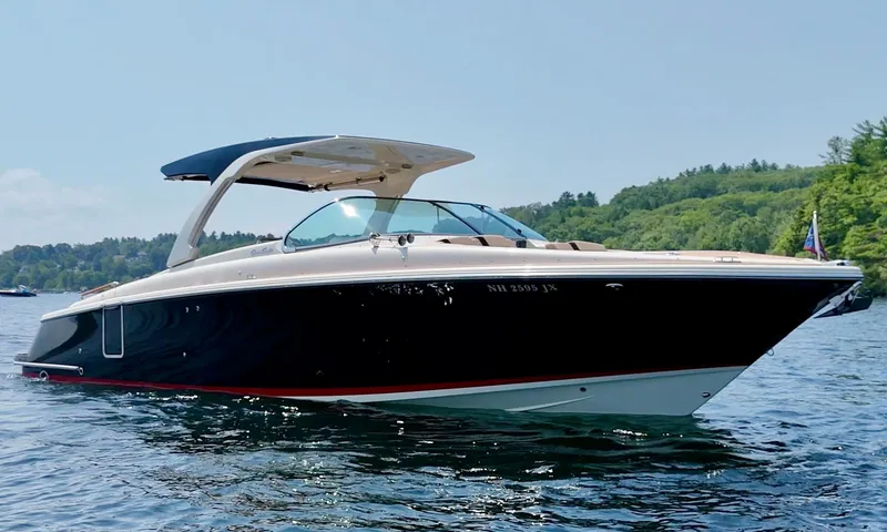 Slide: The Image of 2021 Chris-Craft Launch 35 GT boat on a serene lake with lush green background. - 2