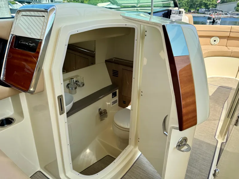 Slide: The Image of 2021 Chris-Craft Launch 35 GT boat interior with compact bathroom and elegant wood accents. - 20