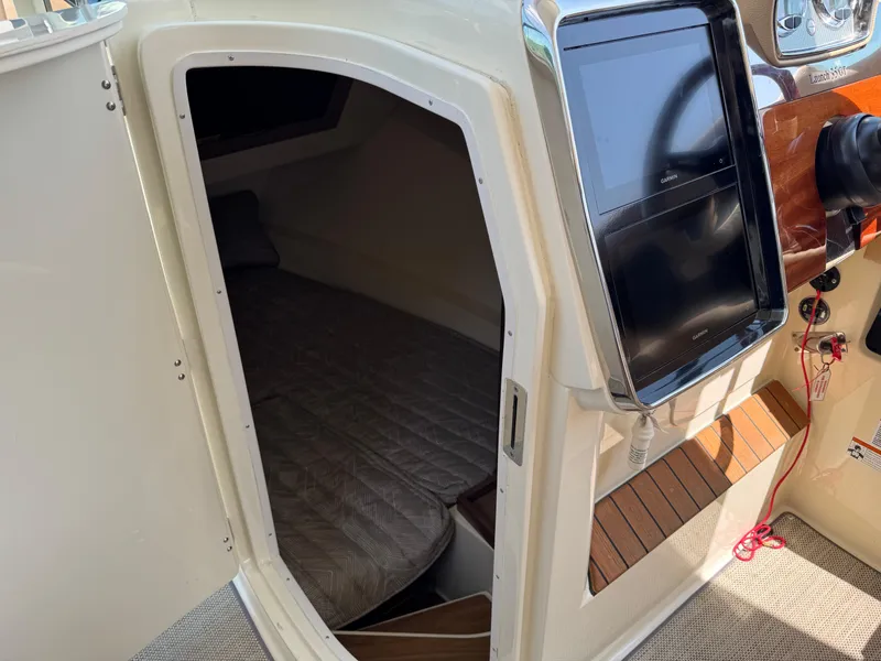Slide: The Image of 2021 Chris-Craft Launch 35 GT cabin interior with bed and navigation panel. - 22
