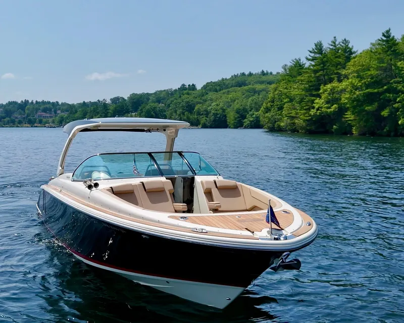 Slide: The Image of 2021 Chris-Craft Launch 35 GT boat cruising on a scenic lake. - 4