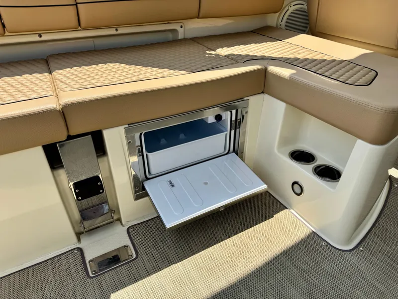Slide: The Image of 2021 Chris-Craft Launch 35 GT interior with open storage compartment and cup holders. - 8