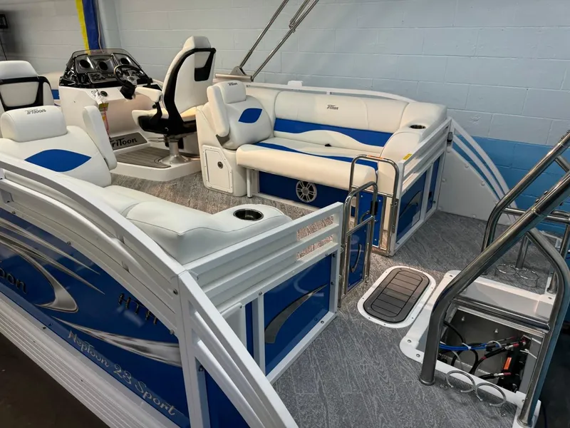Slide: The Image of 2024 JC Neptoon 23 TT DSL pontoon boat interior with blue and white seating. - 12