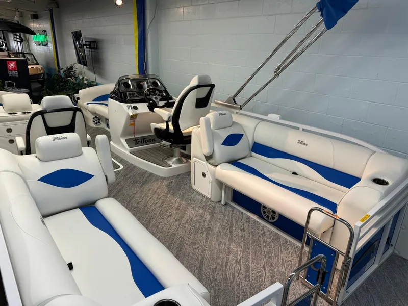 Slide: The Image of 2024 JC Neptoon 23 TT DSL pontoon boat interior with white and blue seating. - 13