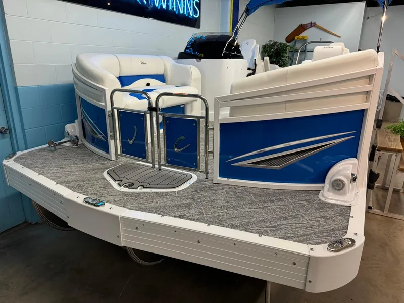 Slide: The Image of 2024 JC Neptoon 23 TT DSL pontoon boat with blue and white design in showroom. - 18