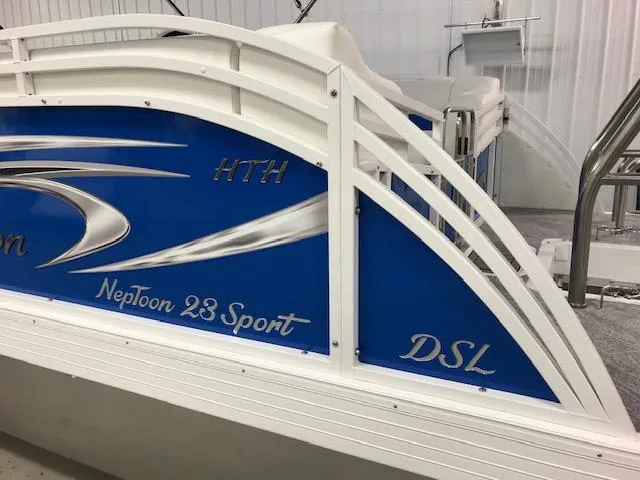 Slide: The Image of 2024 JC Neptoon 23 TT DSL pontoon boat with blue and white design. - 2