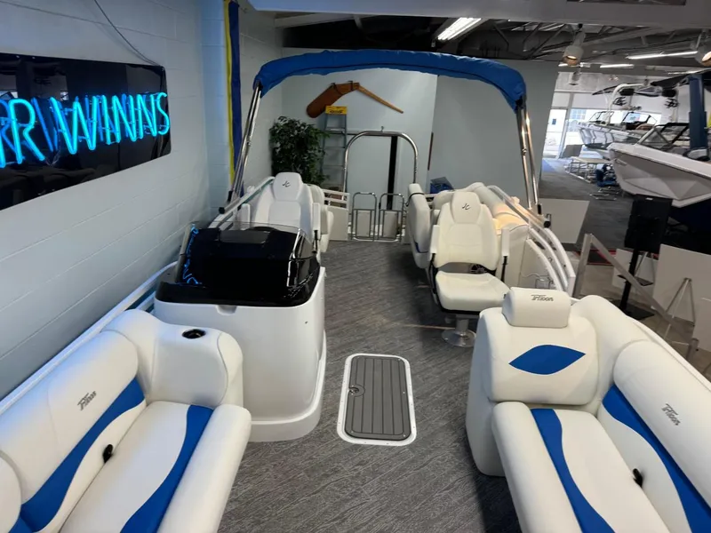 Slide: The Image of 2024 JC Neptoon 23 TT DSL pontoon boat interior with blue and white seating. - 21