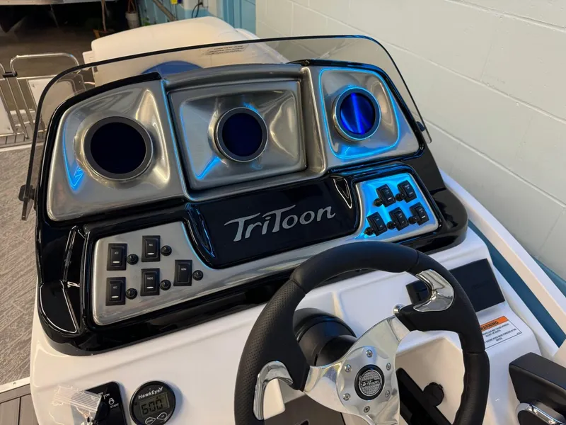 Slide: The Image of 2024 JC Neptoon 23 TT DSL boat dashboard with steering wheel and control panel. - 26