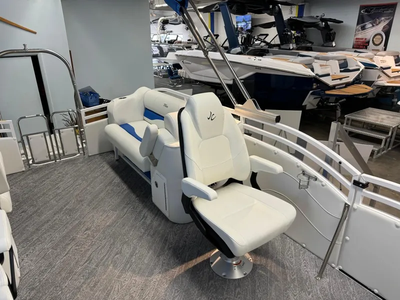Slide: The Image of 2024 JC Neptoon 23 TT DSL pontoon boat interior with white seating and modern design. - 29