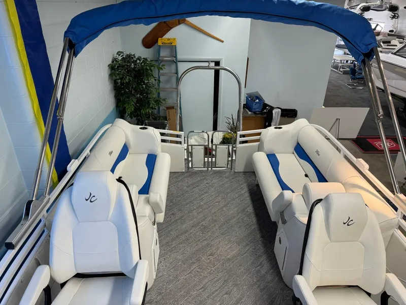 Slide: The Image of 2024 JC Neptoon 23 TT DSL pontoon boat with white and blue seating. - 30
