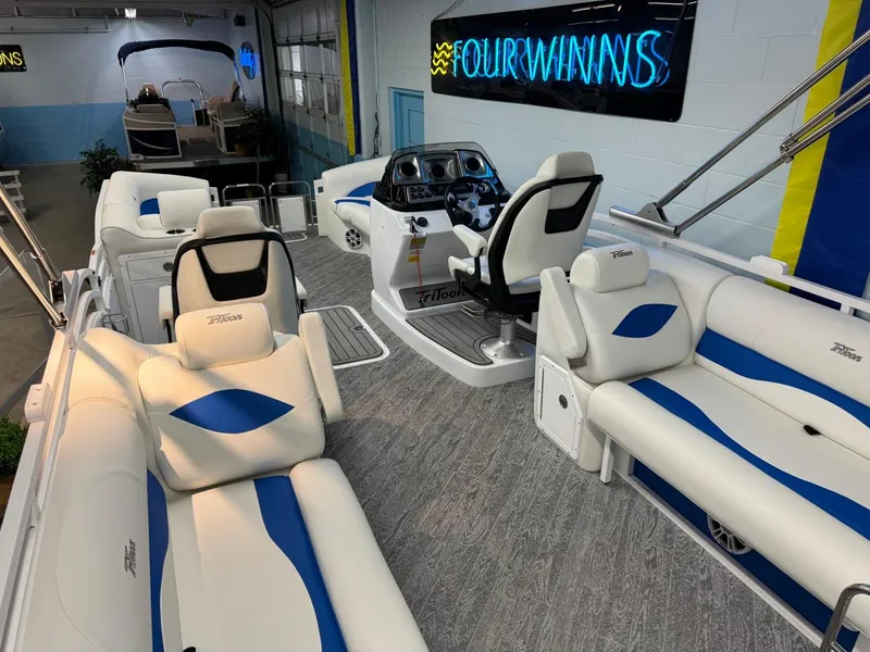 Slide: The Image of 2024 JC Neptoon 23 TT DSL pontoon boat interior with white and blue seating. - 32