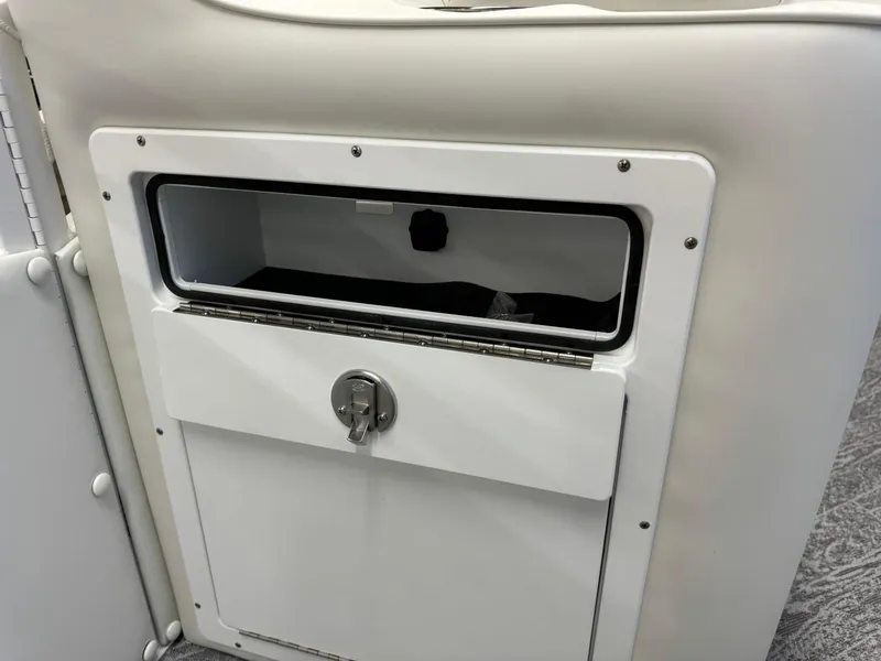 Slide: The Image of 2024 JC Neptoon 23 TT DSL storage compartment with lock, white interior. - 37