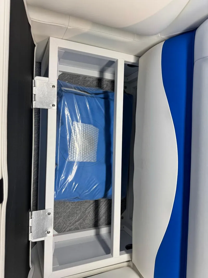 Slide: The Image of 2024 JC Neptoon 23 TT DSL boat storage compartment with blue cushion. - 39