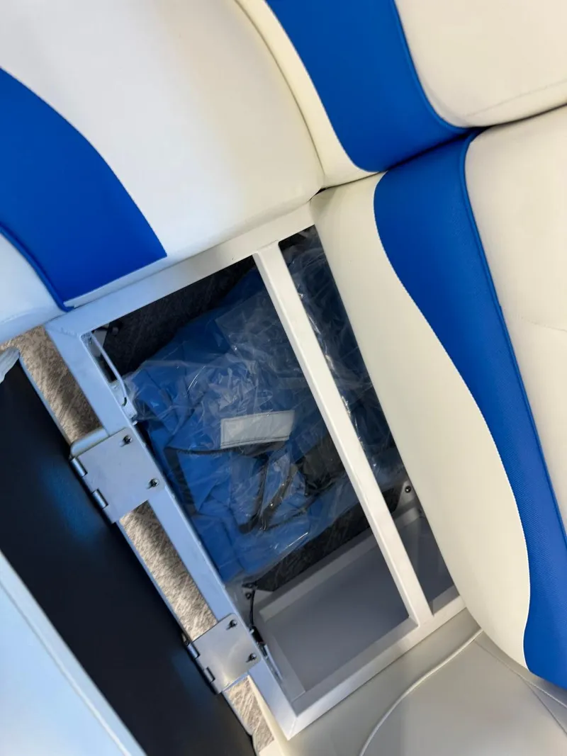 Slide: The Image of 2024 JC Neptoon 23 TT DSL boat seat storage compartment with blue and white upholstery. - 40