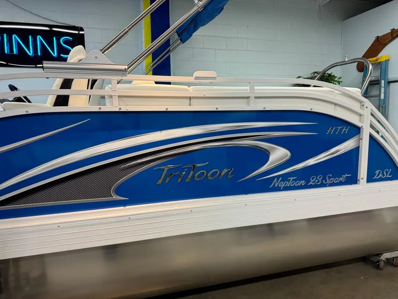 Slide: The Image of 2024 JC Neptoon 23 TT DSL pontoon boat with blue and silver design. - 42